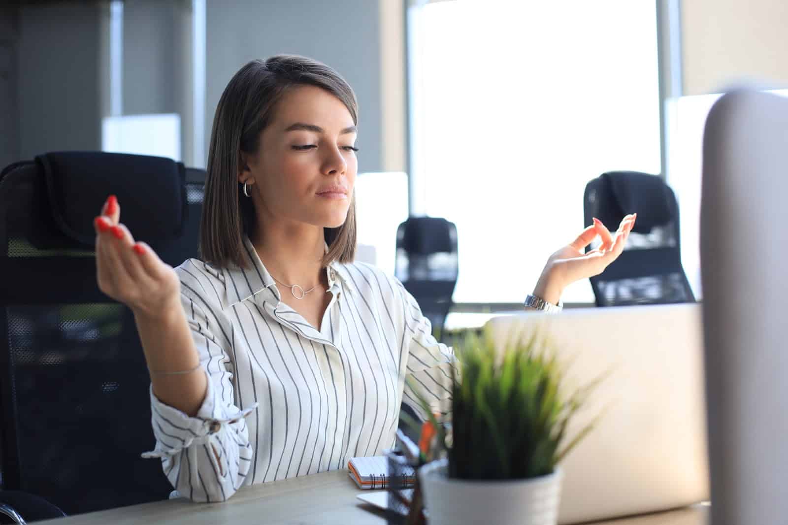 businesswoman-doing-yoga-at-work