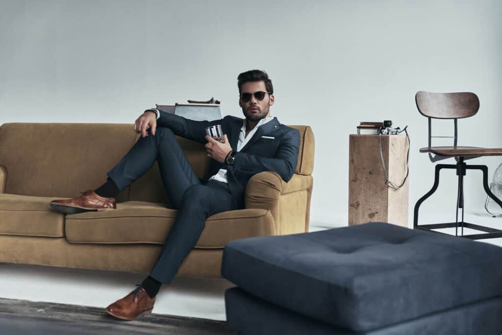 man-in-suit-sitting-on-couch