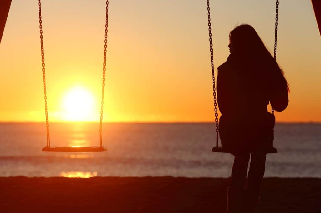 woman-alone-swinging-on-the-beach