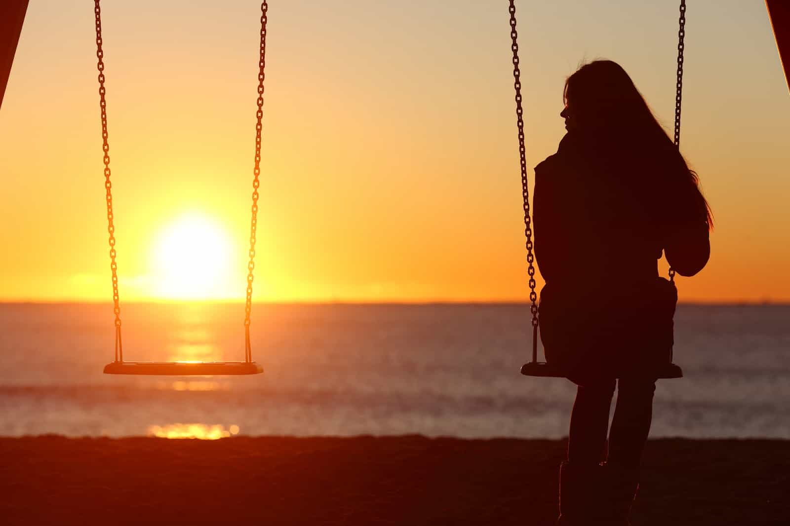 woman-alone-swinging-on-the-beach