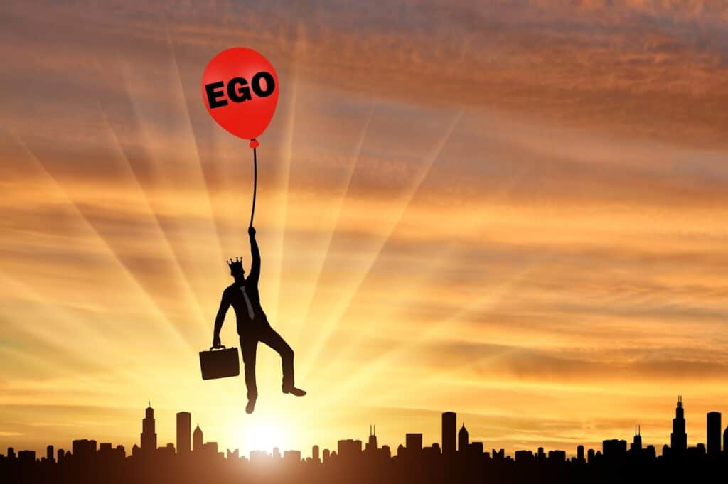 selfish-businessman-holding-balloon-with-ego-lettering