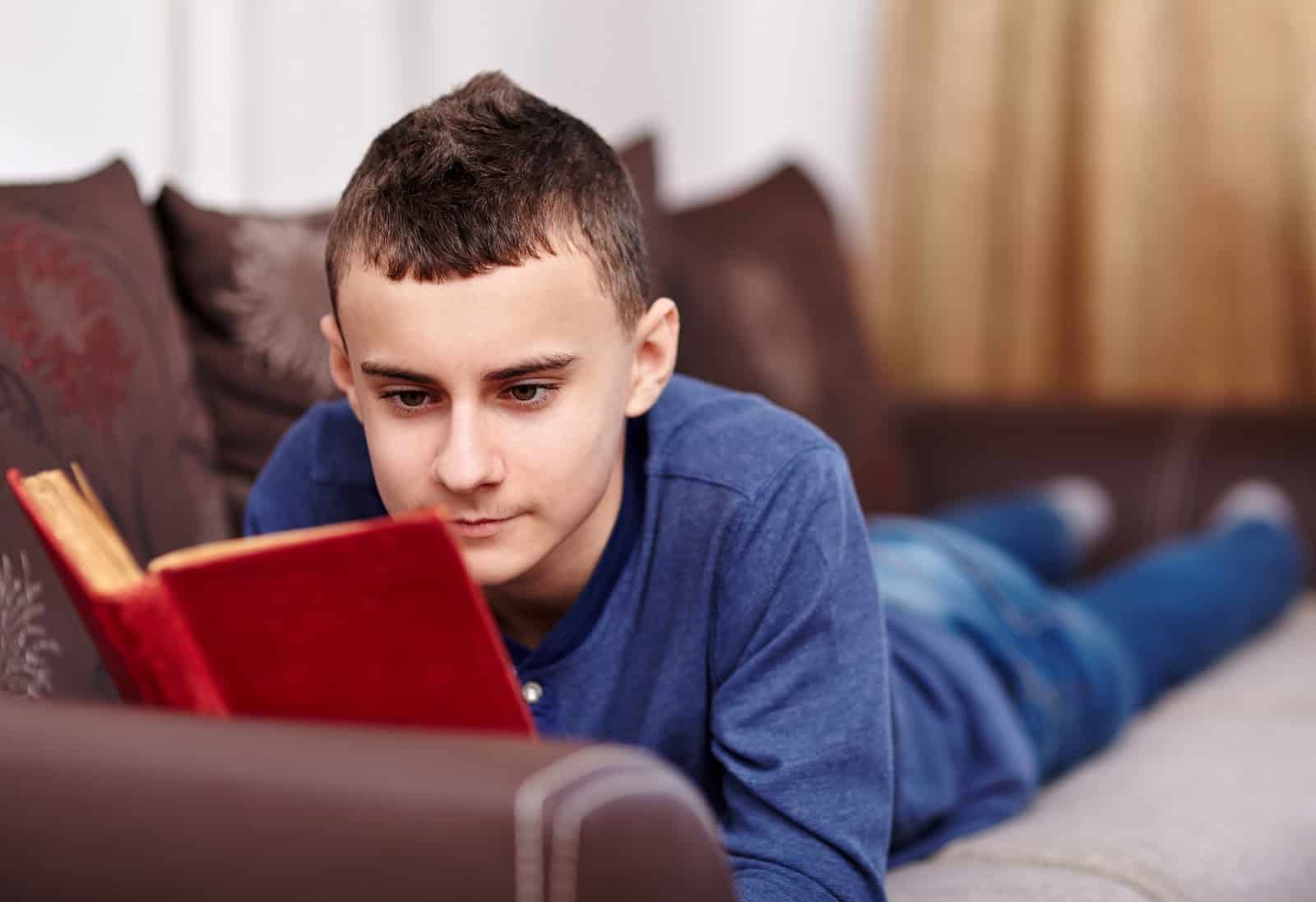 teen-reading-a-book-on-a-couch