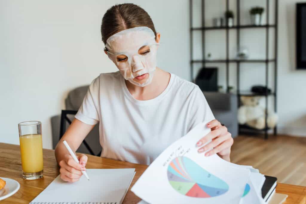 woman-with-face-mask-writing-in-notebook