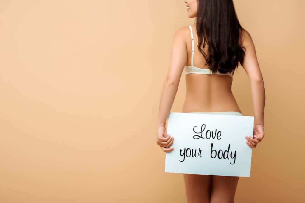 woman-holding-love-your-body-sign