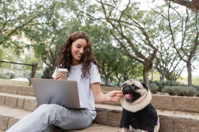 independent woman freelancer at a park with her pet dog