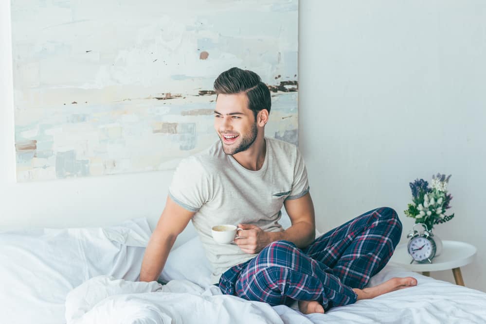 man-enjoying-coffee-in-bed