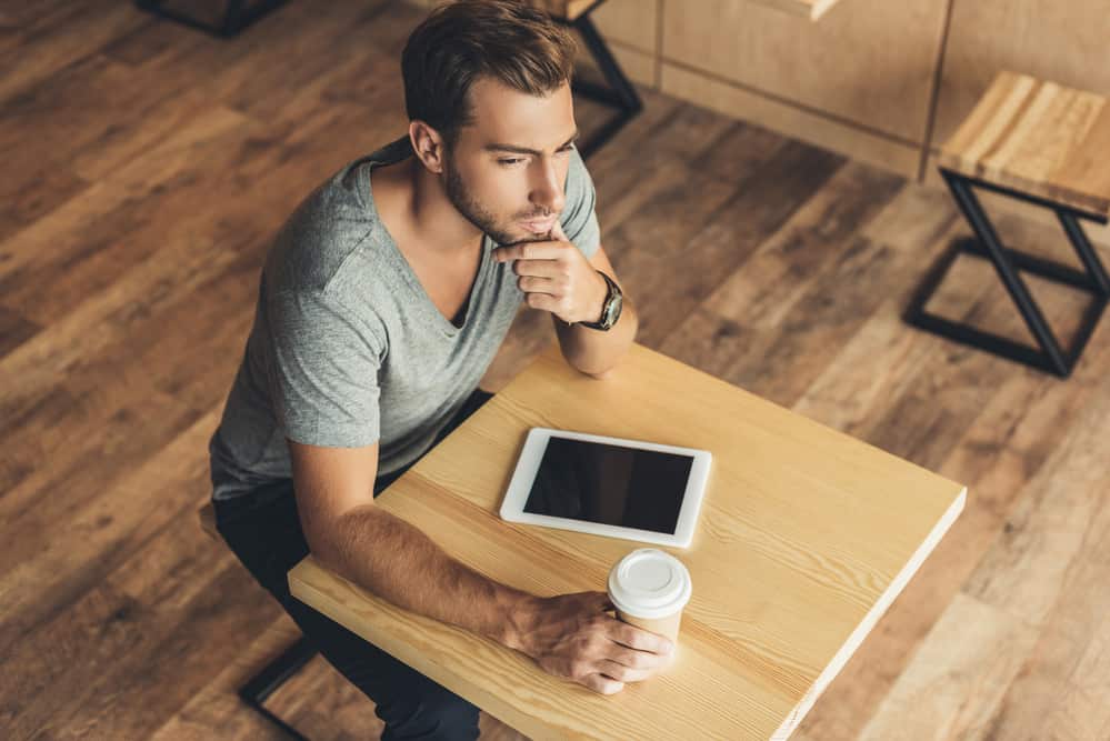 man-in-deep-thought-at-cafe