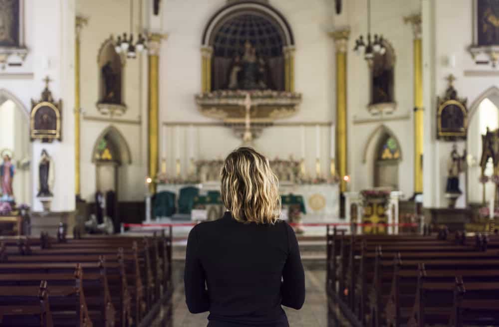 woman-praying-alone-at-church