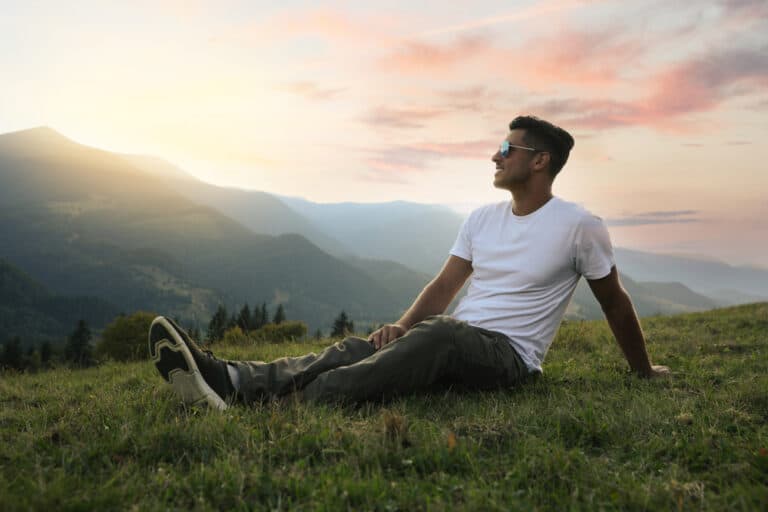 man-enjoying-mountainside-scene-at-sunset