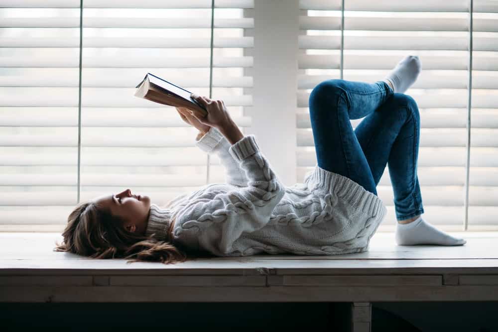 woman-reading-on-window-sill