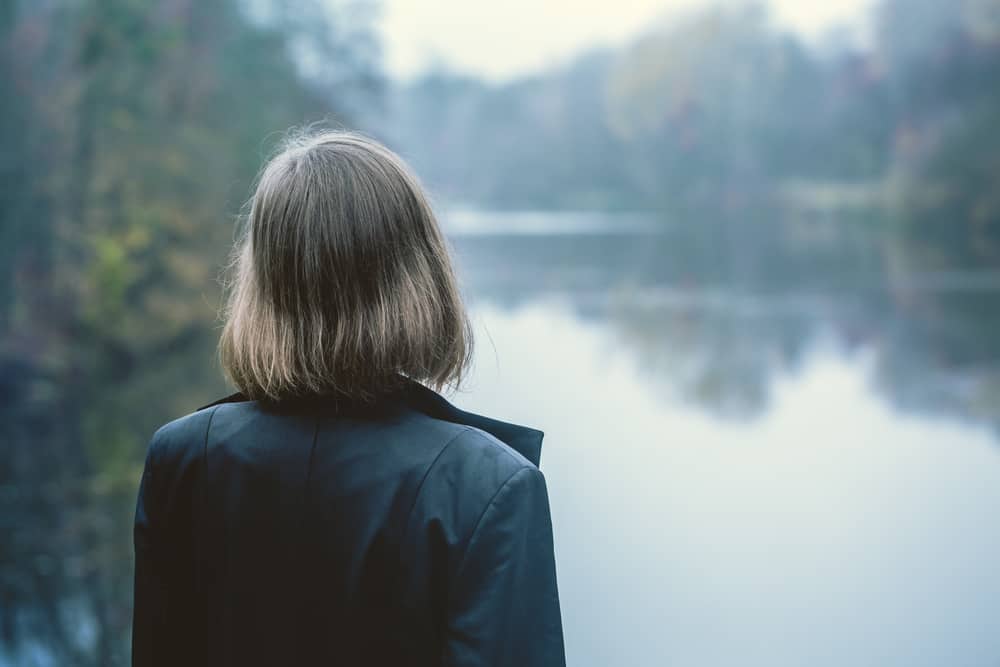 woman-over-looking-lake-side-view
