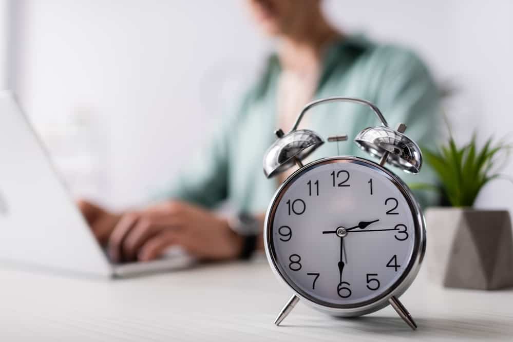 alarm-clock-with-man-working-in-background