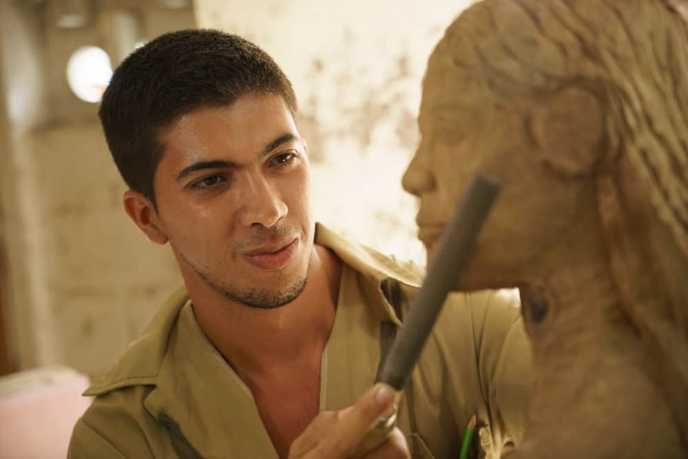 young-sculptor-working-on-a-sculpture