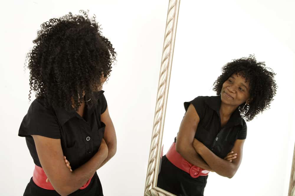 woman-looking-at-reflection-of-herself-in-mirror
