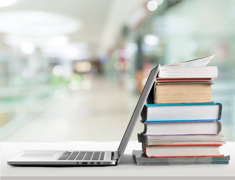 stack-of-books-with-laptop