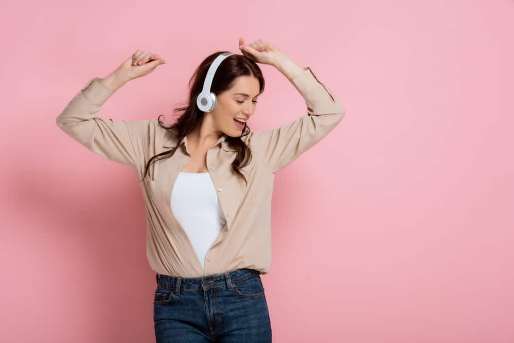 woman-wearing-headphones-dancing-happy