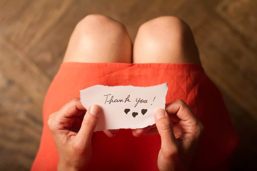 woman-holding-thank-you-note