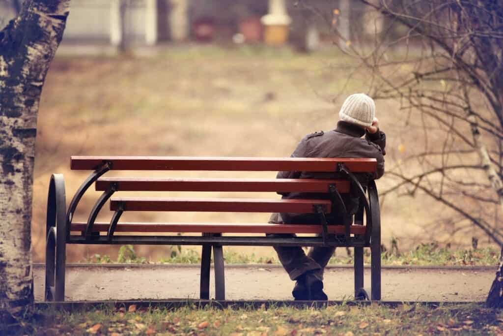 lonely-man-sitting-on-a-park-bench
