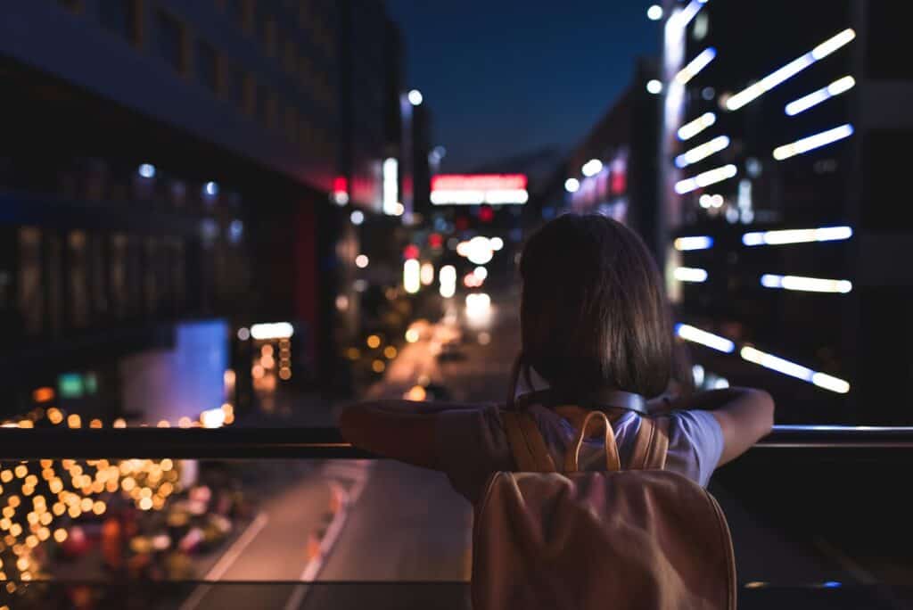 woman-overlooking-city-scape-at-night