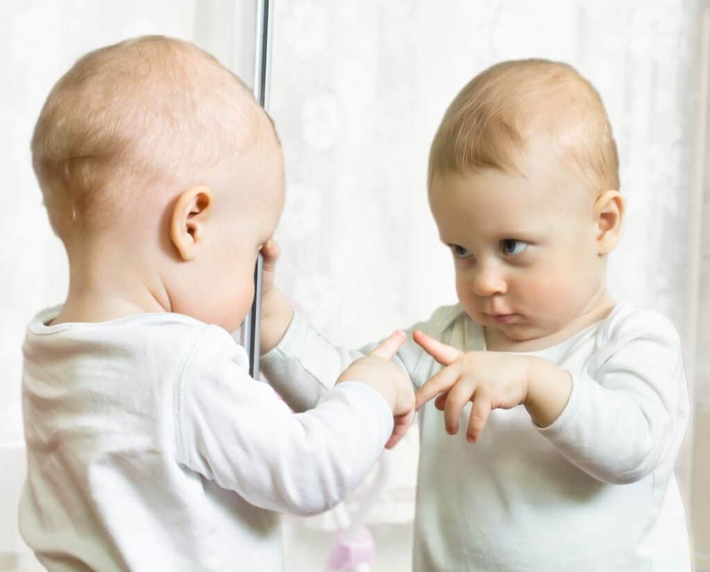 baby-looking-at-reflection-in-mirror