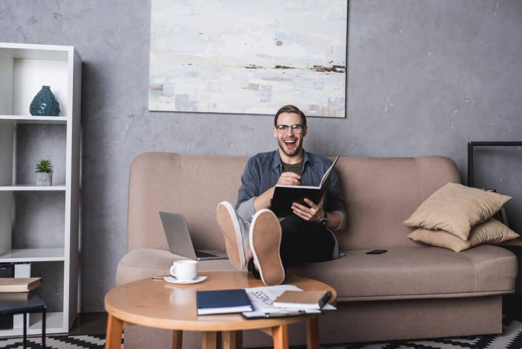 happy-man-reading-a-book-at-home