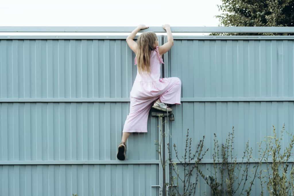 girl-climbing-fence