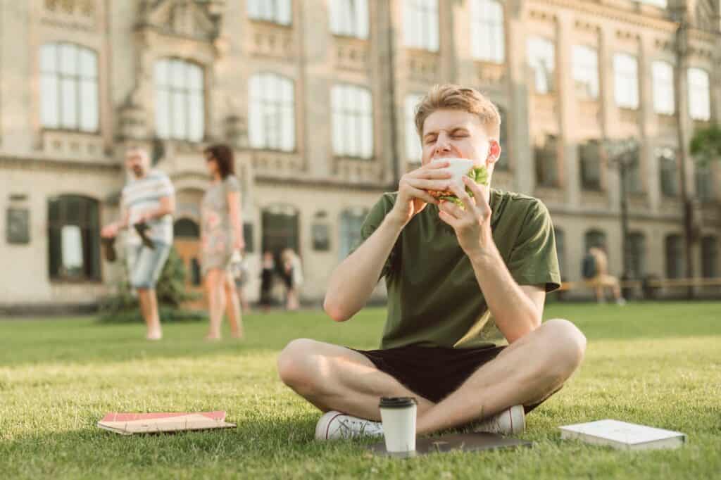 student-enjoying-lunch-on-school-lawn