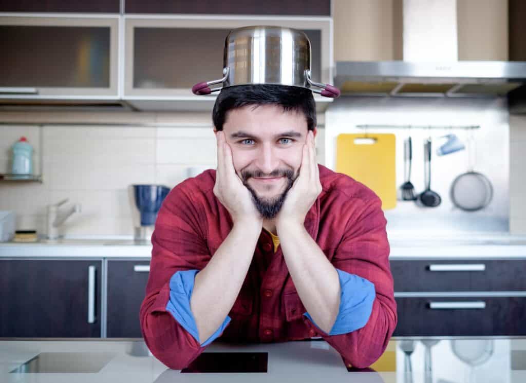 man-with-pot-on-head-in-kitchen