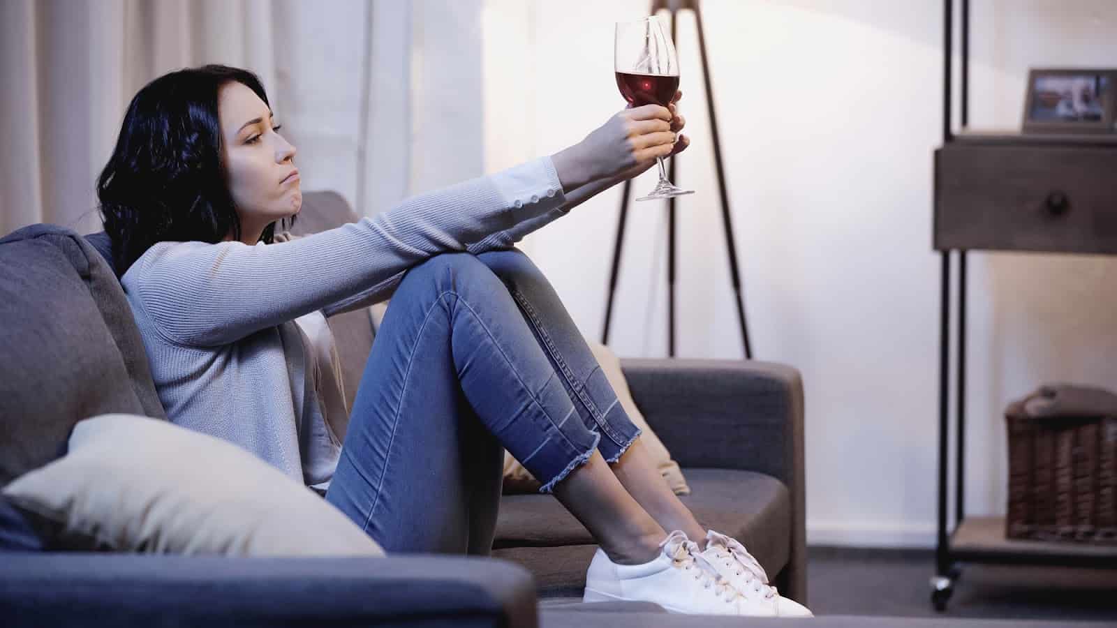 woman-sitting-on-couch-with-wine