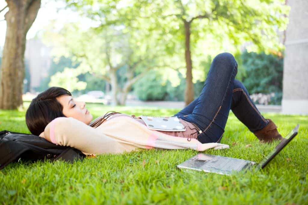 college-student-taking-a-nap-on-college-campus