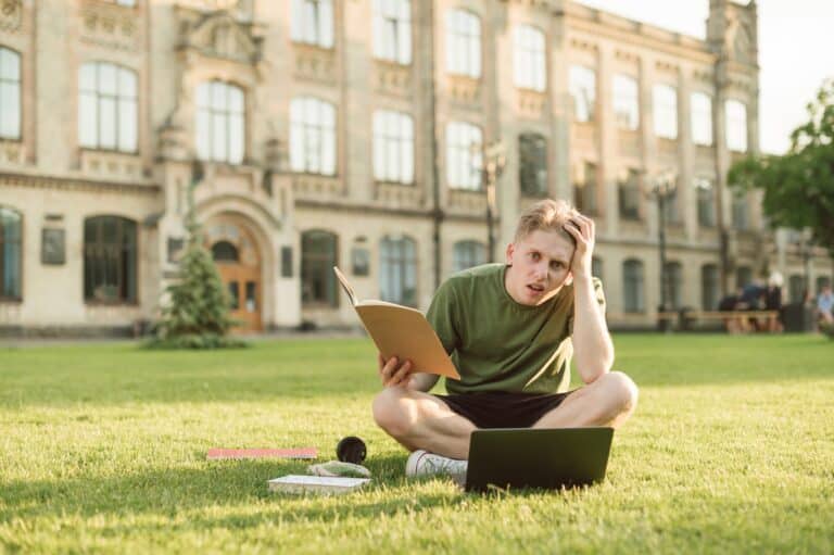 young-college-student-studying-alone-on-college-grounds