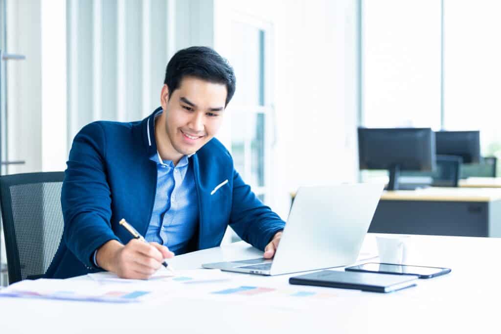 young-asian-businessman-working-at-his-desk