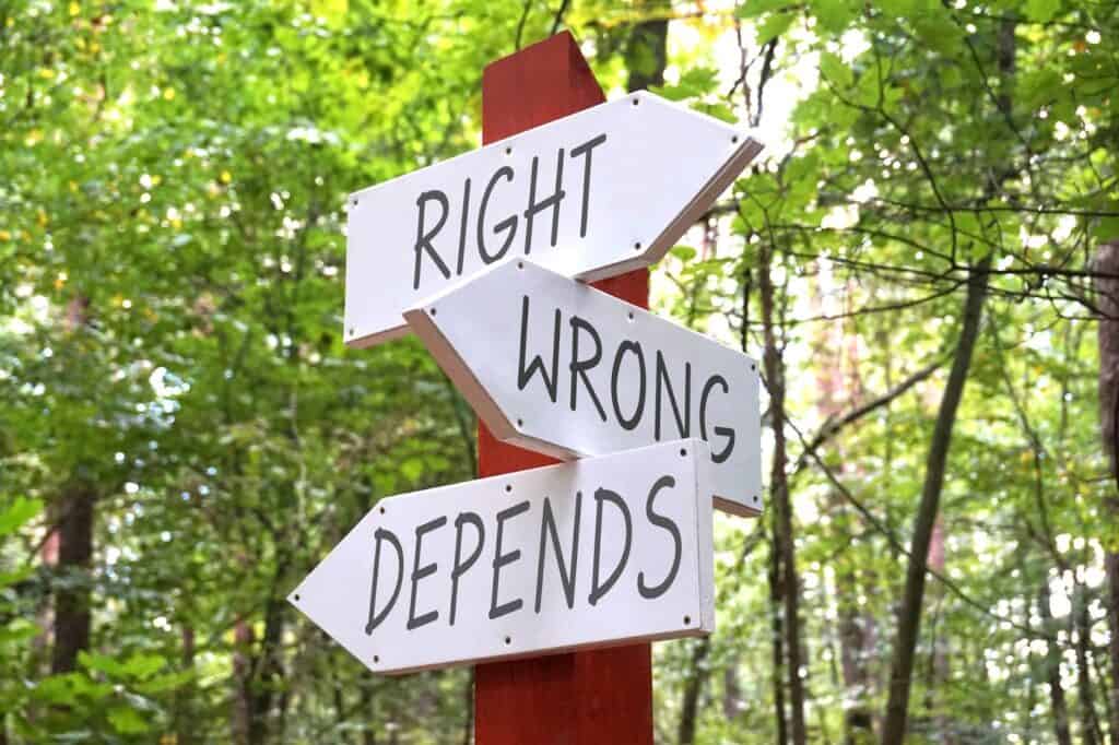 right-wrong-depends-wooden-signpost-with-three-arrows-forest-in-background