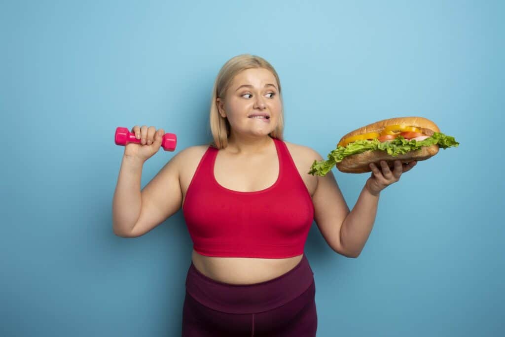 fat-woman-does-gym-and-want-to-eat-a-sandwich-concept-of-food-temptation