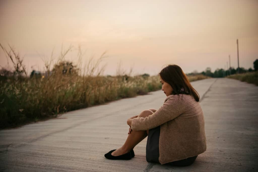 portrait of lonely woman alone in a field