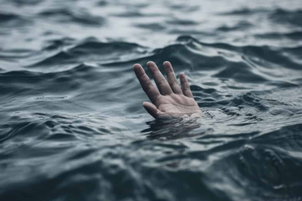 drowning-hand-outstretched-for-help-lost-at-sea