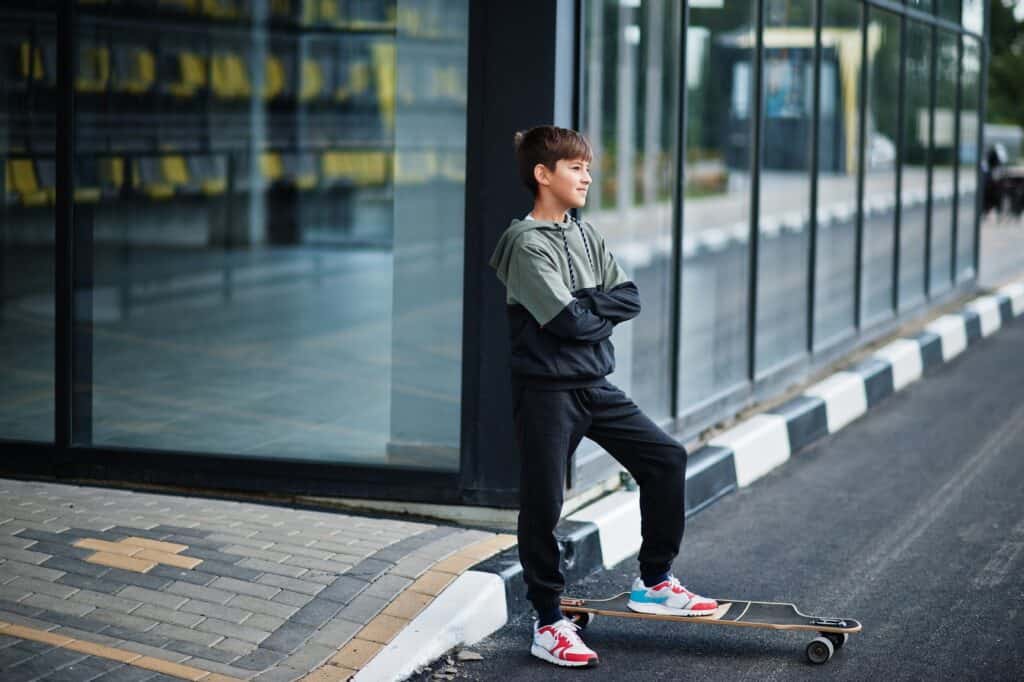 teenager-boy-in-a-sports-suit-with-longboard