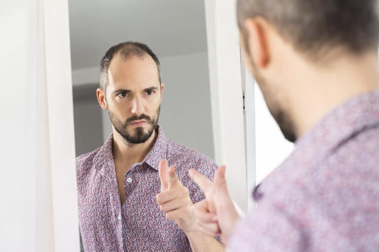 man-pointing-at-himself-in-mirror