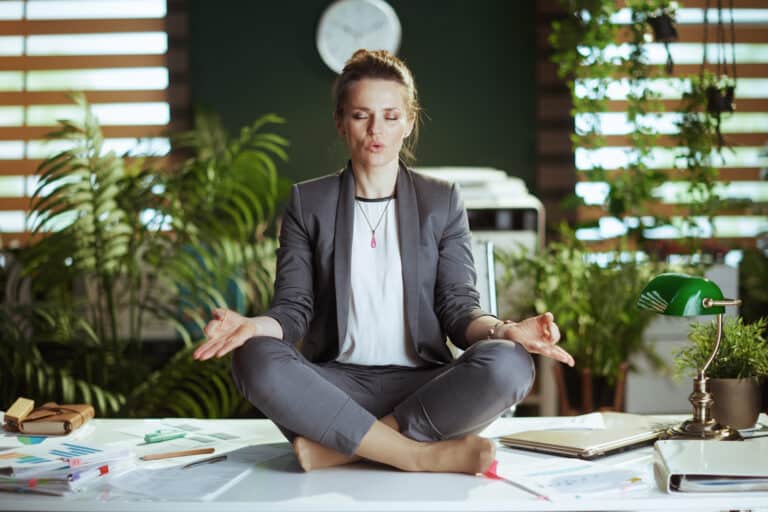 stress-management-business-woman-meditating-in-office