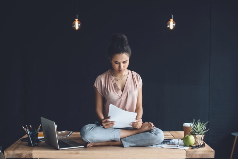 woman-sitting-on-desk