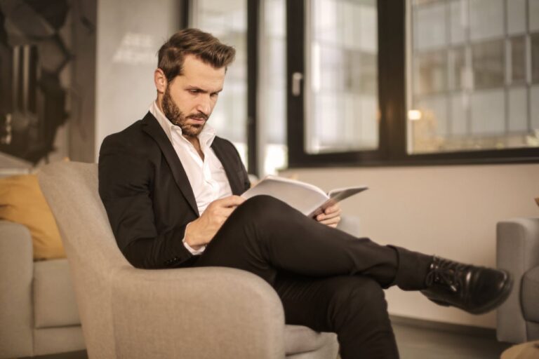 man in suit reading