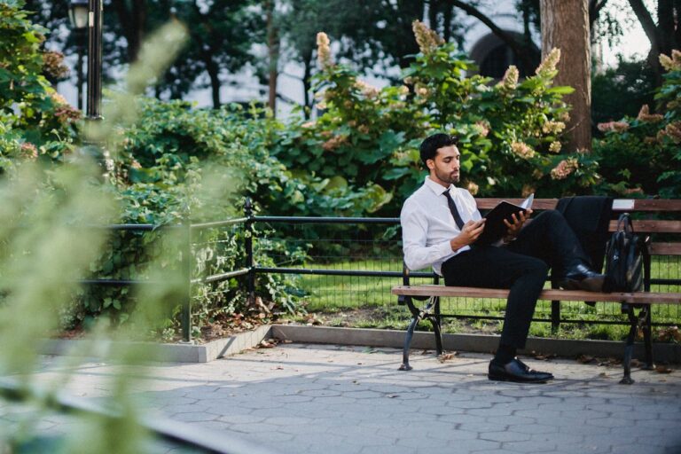 man reading on bench